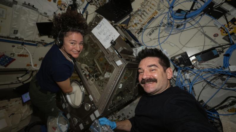 NASA astronauts Jessica Meir and Jack Hathaway work together to process stem cell samples aboard the Kibo laboratory module. Meir nourished the stem cells inside Kibo’s Life Science Glovebox after Hathaway retrieved them from a science freezer, thawed them, and handed them over for treatment. The research may lead to the development of space-designed therapies to treat cancer and blood conditions.