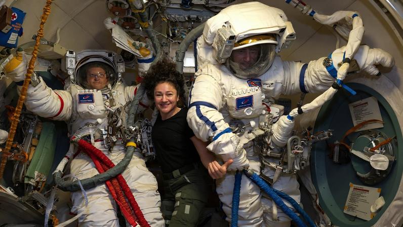 Roscosmos cosmonauts Sergey Kud-Sverchkov (left) and Sergei Mikaev (right), Expedition 74 commander and flight engineer respectively, are pictured inside the Poisk module's airlock trying on their Orlan spacesuits as NASA flight engineer Jessica Meir assists them. The duo was preparing for a spacewalk to install a solar radiation experiment and remove biological exposure hardware on the outside of the International Space Station.
