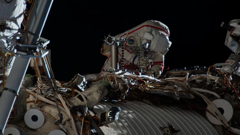 Roscosmos cosmonaut Sergey Kud-Sverchkov works outside the International Space Station in his Orlan spacesuit with red stripes. During the six-hour and five-minute spacewalk, Kud‑Sverchkov, along with Roscosmos cosmonaut Sergei Mikaev (out of frame), installed a solar radiation experiment and removed physics and microbiology research hardware from the orbital outpost.