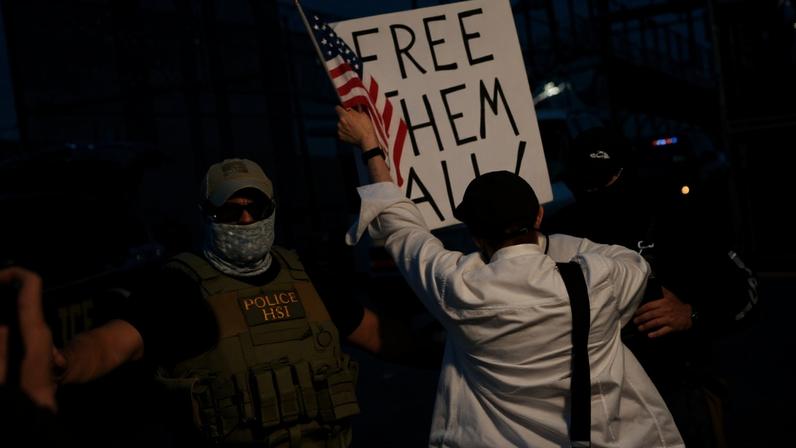 NEWARK, NEW JERSEY - MAY 29: Immigration and Customs Enforcement (ICE) agents stand guard in front of protesters outside Delaney Hall which is being used as an Immigration and Customs Enforcement detention center on May 29, 2026 in Newark, New Jersey. Confrontations between ICE agents and protestors, who are supporting detainees held in the facility and continue to participate in a hunger strike and have put out a list of demands. Michael M. Santiago/Getty Images/AFP (Photo by Michael M. Santiago / GETTY IMAGES NORTH AMERICA / Getty Images via AFP)