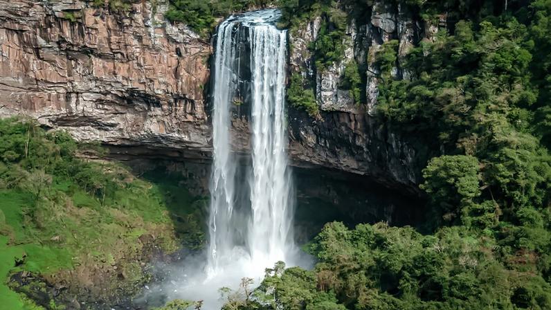 Paisagem da Serra Gaúcha com vegetação e cachoeira, remetendo ao ambiente natural de Nova Pádua RS