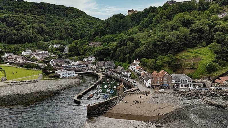 Getty Images Aerial view of small harbour village in England with fishing boats moored between breakwaters (Credit: Getty Images)