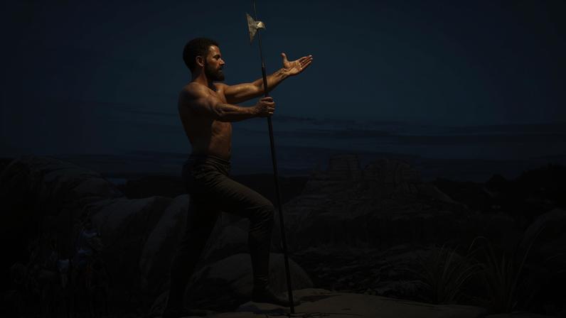 A depiction of Estevanico, holding a halberd with his arms outstretched atop a scenic outlook (Credit: Granger)