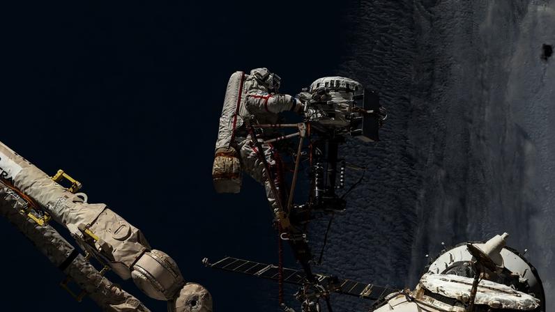 Roscosmos cosmonaut Sergey Ryzhikov is pictured at the end of the European robotic arm as he works on a high‑resolution camera during a six‑hour, nine‑minute spacewalk outside the International Space Station on Oct. 16, 2025.