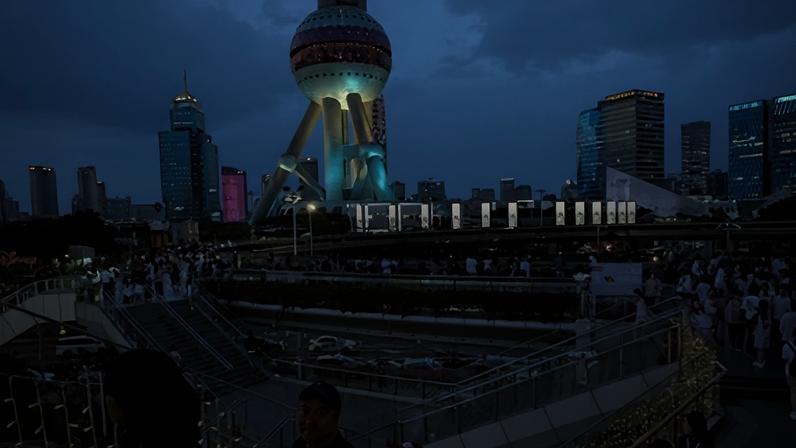 Pessoas caminham em ponte destinada a pedestres no distrito financeiro de Lujiazui,. em Xangai, na China