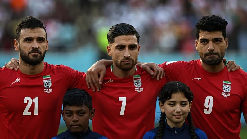 Iran's midfielder #21 Ahmad Noorollahi, Iran's midfielder #07 Alireza Jahanbakhsh and Iran's forward #09 Mehdi Taremi listen to the national anthem ahead of the Qatar 2022 World Cup Group B football match between England and Iran at the Khalifa International Stadium in Doha on November 21, 2022. (Photo by Fadel Senna / AFP) (Fadel Senna/AFP)