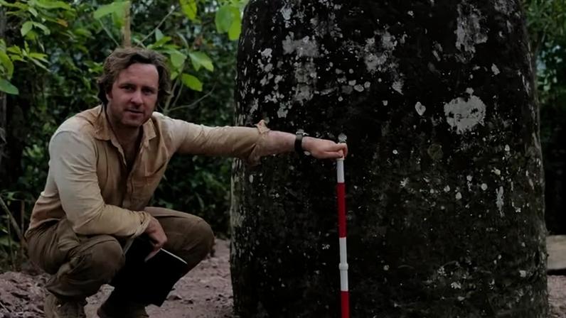 Nicholas Skopal, an archaeologist at James Cook University in Australia, with a stone jar in Laos.