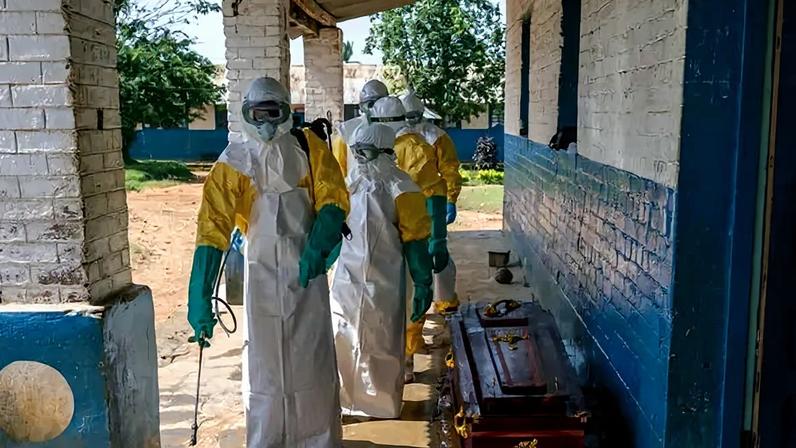 Health workers disinfected a coffin containing the body of a man presumed have died of Ebola in the Democratic Republic of Congo.
