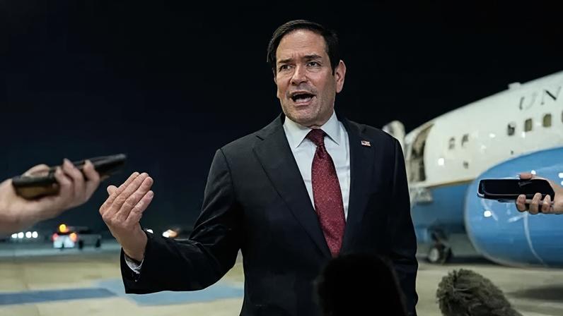 Secretary of State Marco Rubio speaking to reporters after landing in Abu Dhabi
