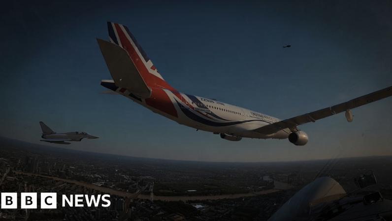 An image taken from a plane, showing two other planes flying alongside it as part of the King's Birthday Flypast.
