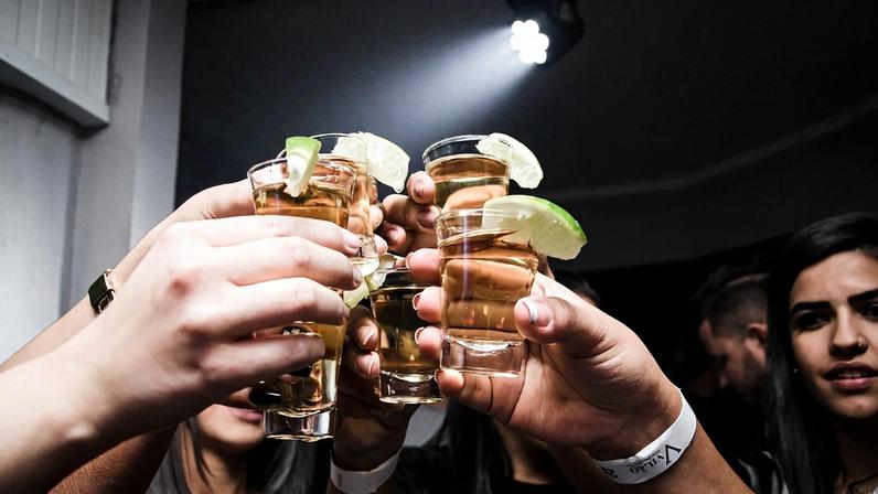 mãoes brindando com tequilas