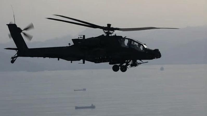 An AH-64 Apache flying above the strait of Hormuz.