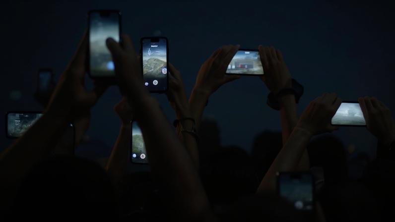 People holding up cellphones at a concert in Toronto.