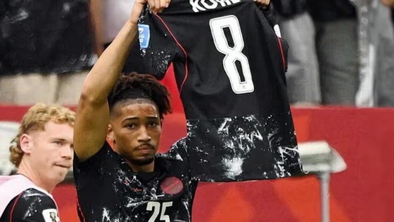 Nathan Saliba holds up the jersey of injured teammate Ismaël Koné after scoring Canada’s fourth goal in the second half on Thursday.