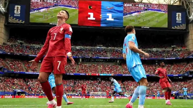 HOUSTON, TEXAS – JUNE 17: Cristiano Ronaldo #7 of Portugal is challenged by Axel Tuanzebe #4 of Congo DR during the FIFA World Cup 2026 Group K match between Portugal and Congo DR at Houston Stadium on June 17, 2026 in Houston, Texas. (Photo by Lars Baron/Getty Images)
