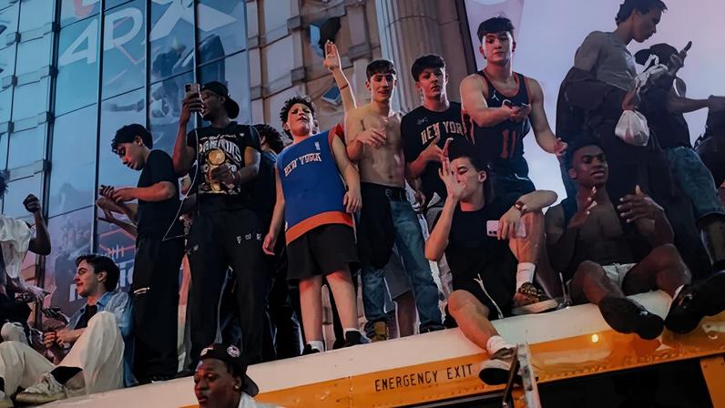 Young Knicks fans climbed atop a school bus in Manhattan to celebrate the team’s championship win on Saturday.