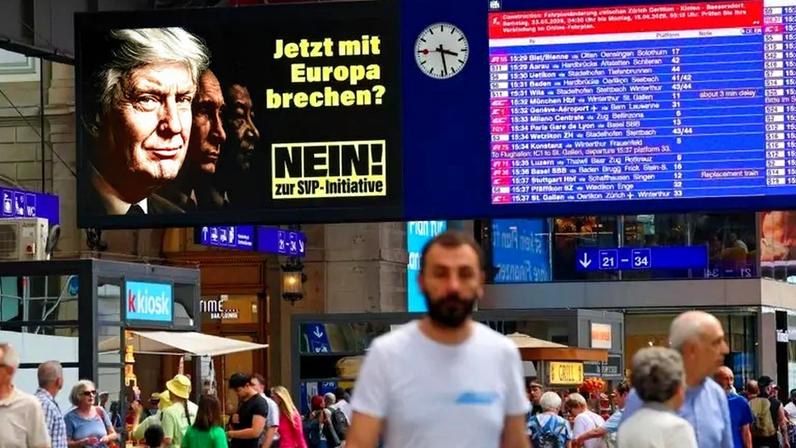 Cartazes mostram Donald Trump, Vladimir Putin e Xi Jinping, alertando contra “romper com a Europa”