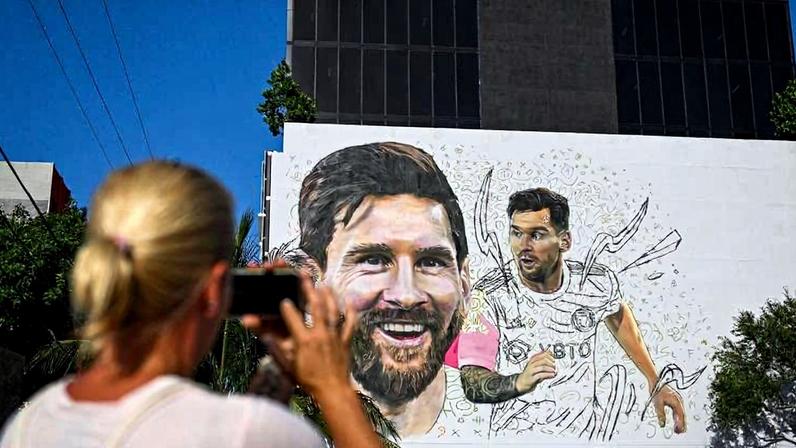 Mulher tira foto de mural com rosto de Lionel Messi em Miami