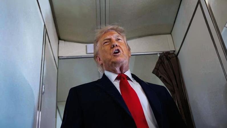 O presidente Donald Trump fala com repórteres a bordo do avião presidencial Air Force One