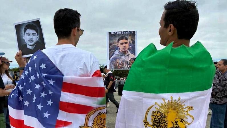 Irmãos usam bandeira usada antes da revolução de 1979, que não foi autorizada a ser usada pela fifa e pelo regime iraniano