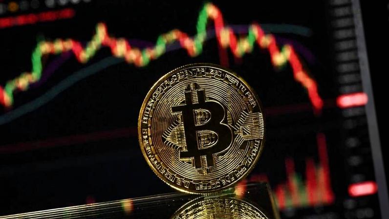Moeda de Bitcoin à frente de um gráfico