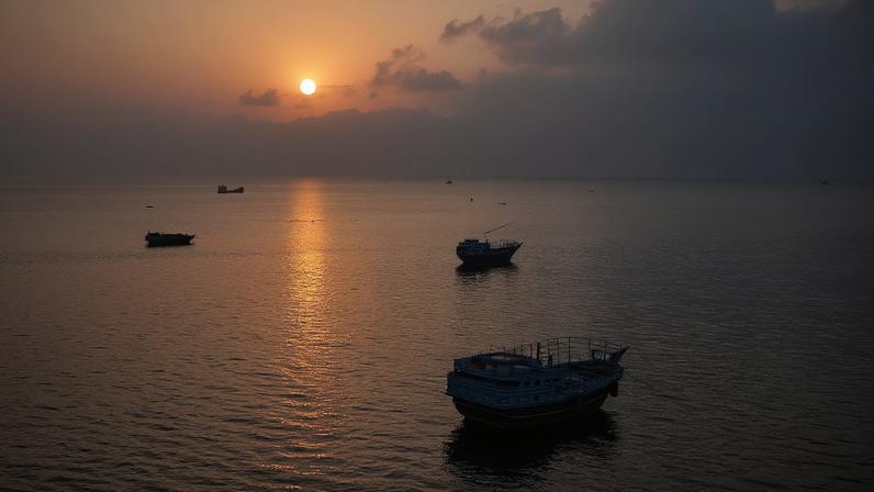 Navios ancorados na costa de Omã, perto do estreito de Hormuz, neste sábado (27)