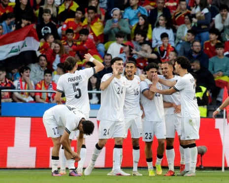 Merchas Doski celebrates with his teammates after scoring Iraq’s equaliser.