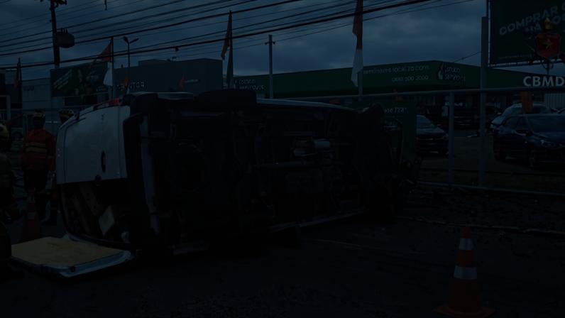 Van Mercedes-Benz branca, utilizada no transporte de mercadorias, tombada na pista após colidir contra um poste de iluminação pública - (crédito: CBMDF)