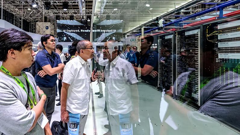 Visitors look at an AI data center display during Computex in Taipei.
