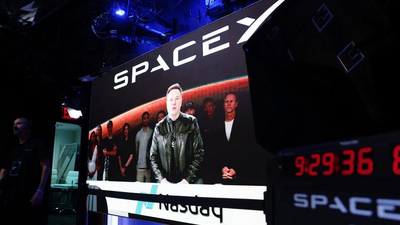 A video displays SpaceX founder Elon Musk during the company’s initial public offering at the Nasdaq MarketSite.