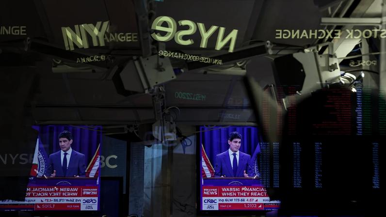 A television station broadcasts Kevin Warsh after a Federal Open Market Committee meeting, on the floor of the New York Stock Exchange.