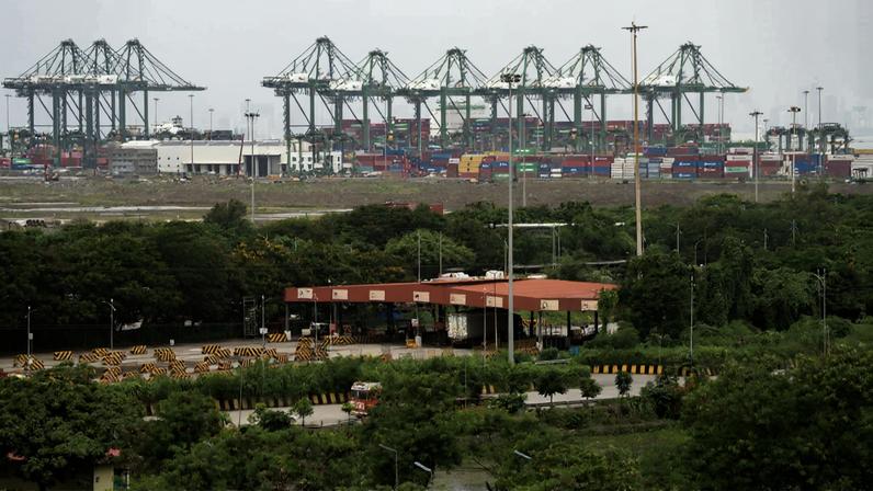 Gantry cranes and shipping containers at Jawaharlal Nehru Port in Navi Mumbai, Maharashtra, India.