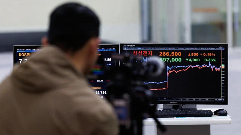 A trader watches stock prices of Samsung Electronics and SK Hynix at the Korea Exchange in Seoul. South Korea’s equity market has overtaken Canada’s as the world’s seventh largest, propelled by insatiable demand for chips powering artificial intelligence.