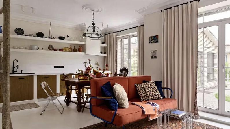 O living é integrado à cozinha, ambos com base neutra e elementos coloridos