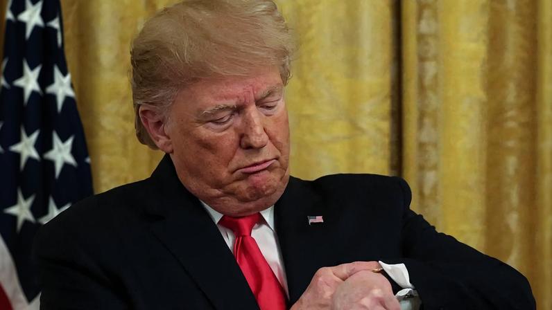 FILE PHOTO: U.S. President Donald Trump checks his watch during an event to celebrate federal judicial confirmations in the East Room of the White House in Washington, D.C., U.S., November 6, 2019. REUTERS/Jonathan Ernst/File Photo
