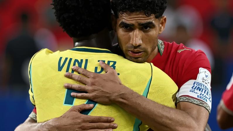 Morocco's Achraf Hakimi embraces Brazil's Vinicius Junior after the match