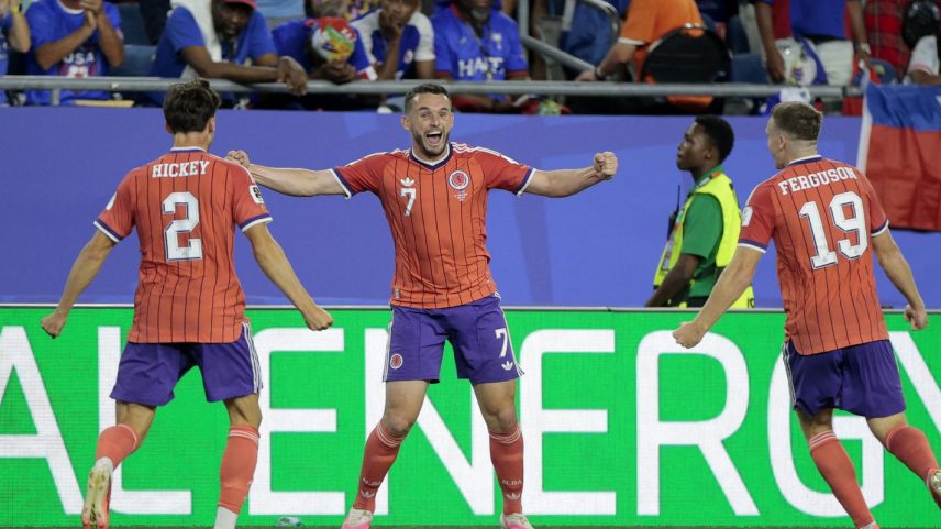 Scotland's John McGinn celebrates scoring their first goal with Aaron Hickey and Lewis Ferguson