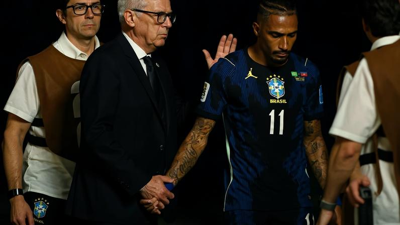 Brazil coach Carlo Ancelotti consoles Raphinha as he walks off the pitch after sustaining an injury