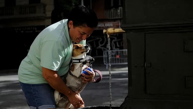 Joana refresca seu cachorro Oli em Barcelona 21 de junho de 2026 REUTERS/Nacho Doce