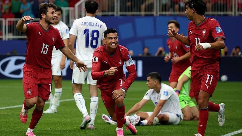 Portugal's Cristiano Ronaldo celebrates with Joao Felix and Joao Neves after Abduvohid Nematov scores an own goal and Portugal's fourth