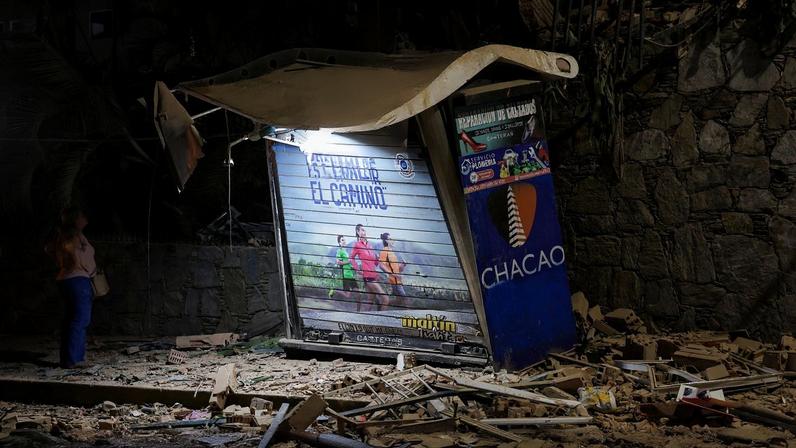 A person looks on near rubble at the site of a collapsed building, after an earthquake, in Caracas, Venezuela, June 24, 2026. REUTERS/Gaby Oraa