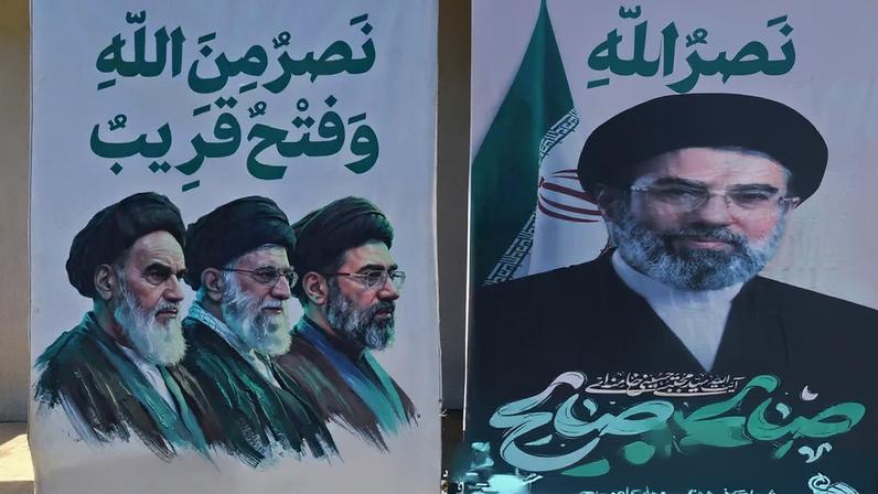 A man walks past a billboard carrying a picture of Iran’ supreme leader Mojtaba Khamenei in Tehran, Iran.
