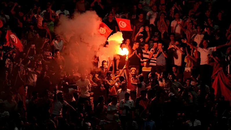 Fans of Tunisia light flares.