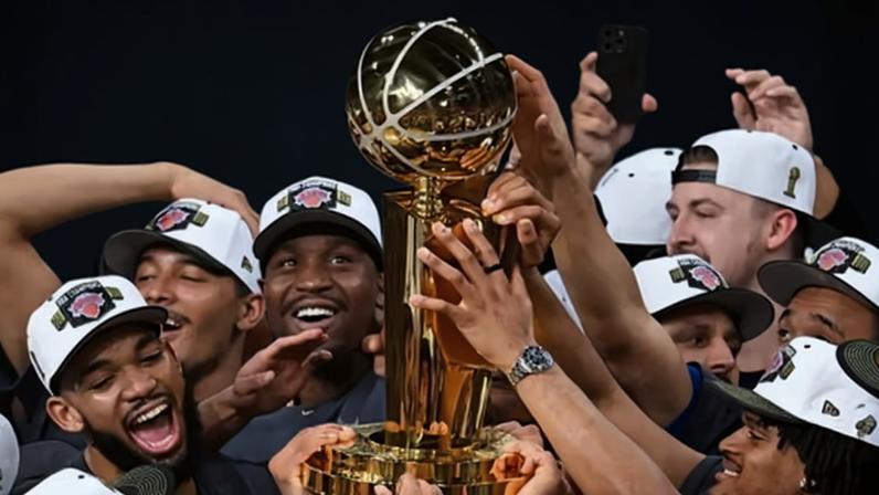 The New York Knicks celebrate with the Larry O'Brien trophy after defeating the Spurs in Game 5 of the NBA finals on Saturday in San Antonio.