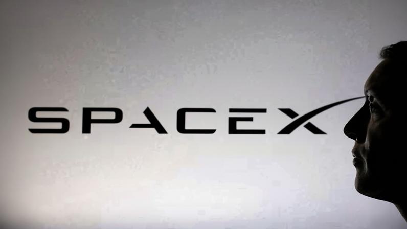 A 3D-printed miniature model of Elon Musk and a SpaceX logo.