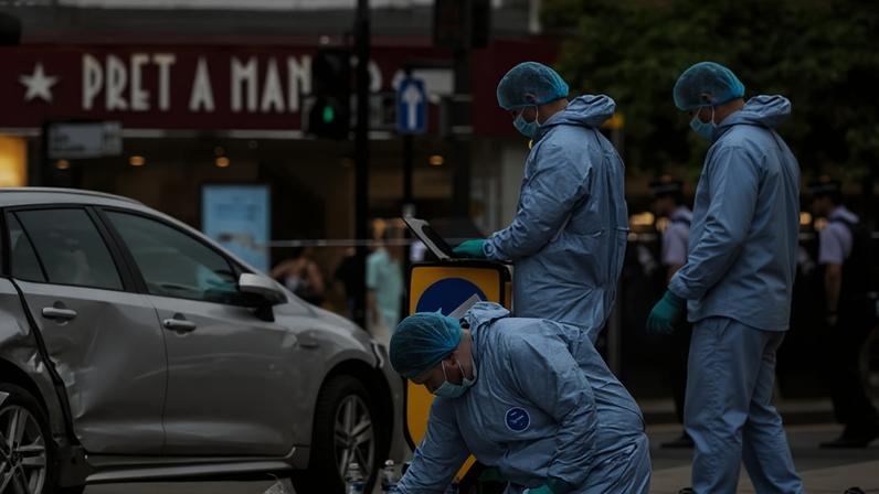 Police forensic officers gather evidence at the scene in west London.