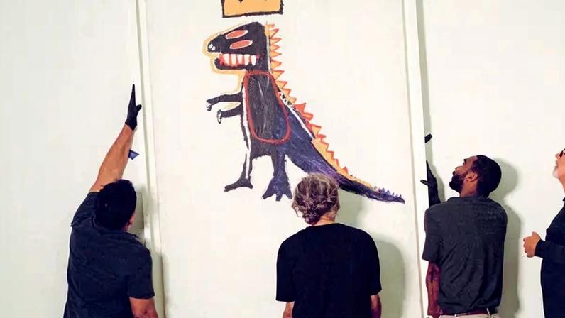 Art handlers install “Pez Dispenser,” 1984, from the Kenneth C. Griffin Collection at a Miami museum. It depicts a dinosaur with a crown atop its head.