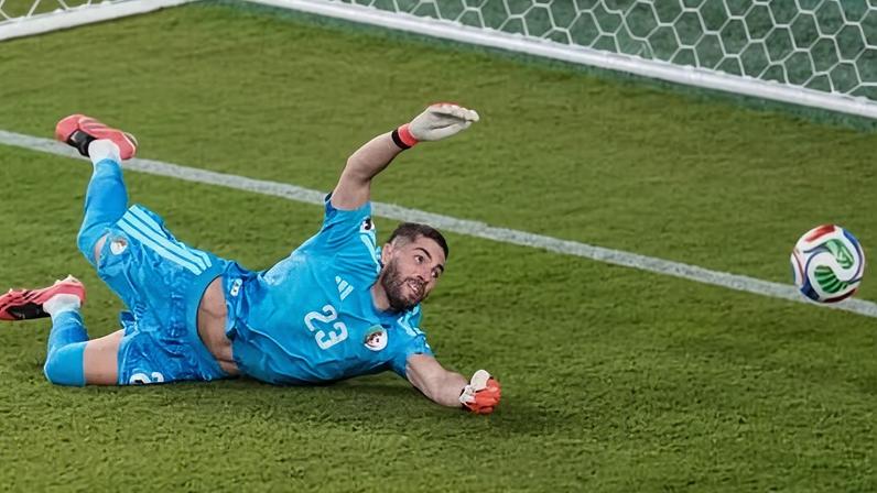 Algeria goalkeeper Luca Zidane watches the ball slip from his grasp against Jordan.