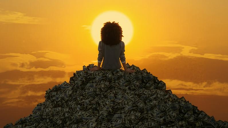 Person sitting on top of a huge pile of dollar bills, facing a bright yellow sun on the horizon