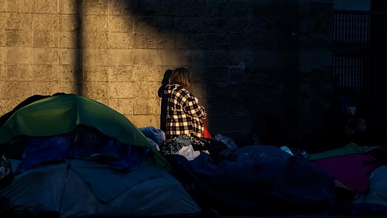 People and tents on a sidewalk in Los Angeles last year.